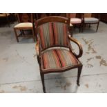 Edwardian inlaid mahogany elbow chair with striped upholstery on square taper front legs and castors