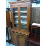 Late Victorian walnut two height bookcase with shelves above enclosed by two glazed doors, two drawe