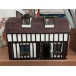 Good quality dolls house by G Ponnock. with electric light fitting and fitted with furniture