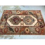 Large rug with geometric decoration on beige and green/brown ground, 299cm x 204cm