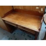 Victorian mahogany writing table with ledge back, two frieze drawers below on shaped pierced end sta