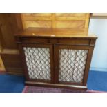 Nineteenth century mahogany chiffonier, with tablet frieze enclosed by a pair of grille doors, on pl
