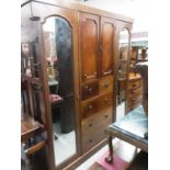 Early 20th century mahogany triple wardrobe, the centre section with two panelled doors, two short a