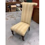 Victorian high back nursing chair with striped upholstery on turned front legs and castors