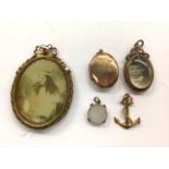9ct gold oval locket, one other glazed locket, 9ct gold anchor charm, 9ct gold mounted mother of pea