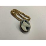 Carved hardstone cameo pendant/brooch in 9ct gold mount on 9ct gold chain