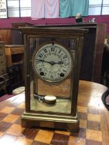 Late 19th century American 8 day mantel clock in brass four-glass case by New Haven Clock Co.