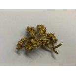 Yellow metal floral spray brooch, stamped 18k