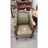 Late Victorian mahogany framed tub chair with green upholstery on cabriole front legs and castors
