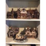Six pieces of studio pottery, including five models of houses and one boat group, all stamped 'Suffo