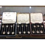Three cases of silver coffee bean end spoons and one other silver spoon