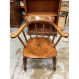 Late 19th century captains chair with spindle back and solid seat on turned legs joined by stretcher