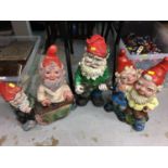Four painted plastic garden gnomes