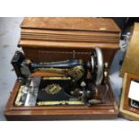 Singer sewing machine in case together with a Harris sewing machine in case (2)