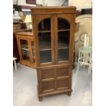 Oak bookcase with shelved interior enclosed by two glazed doors with panelled door below, 62cm wide,