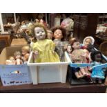 Four boxes of assorted dolls to include walking dolls, porcelain half dolls and others