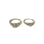 Two 9ct gold diamond solitaire rings with diamond set shoulders