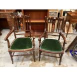 Two Edwardian inlaid mahogany elbow chairs with green padded seats