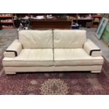 Good quality ivory coloured leather settee and matching armchair