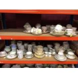 Five shelves containing a large quantity of assorted cups and saucers and other teaware to include R
