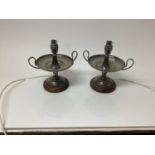 Pair of silver plated table lamps with twin handles and gadrooned borders, on wooden bases
