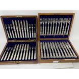 Two sets of Edwardian twelve place setting silver plated fruit cutlery in original fitted cases