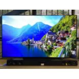 LG OLED flatscreen smart television, model number OLED55B9PLA with remote control, together with an
