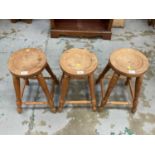 Three Russell Thomas stools, together with one other smaller stool (4)