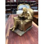 Art Nouveau style gilt metal figural bookend in the form of a seated gentleman, signed J Ruhl