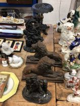 Pair of cast iron lion doorstops, together with a pair of Punch and Judy doorstops, a cast iron stan