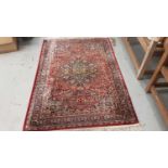 Old rug with floral decoration on red ground