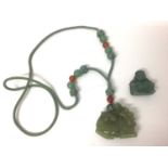 Chinese carved green hardstone figure of a horse, 4.5cm wide, on a woven necklace with polished bead