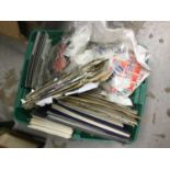Green tub of old postage stamps and First Day Covers.