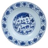 Chinese blue and white dish, 17th century, boldly painted with five deer in a landscape, the rim wit