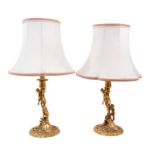 Pair of good quality ormolu candlesticks converted to table lamps with climbing putti and rococo dec