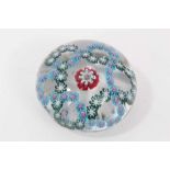 Baccarat glass paperweight - a trefoil blue double garland on a clear ground with a central millefio