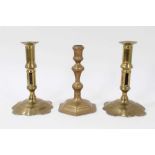 Pair of brass early 18th century candlesticks with shaped bases, together with single Queen Anne can