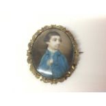 18th century oval portrait miniature on ivory of a young man wearing a blue overcoat, in a later 19t