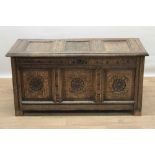18th century carved oak coffer, with triple panel lid and rosette carved triple panel front on stile