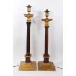 Two large antique columns, one Corinthian and the other Doric, both mounted as table lamps and wired