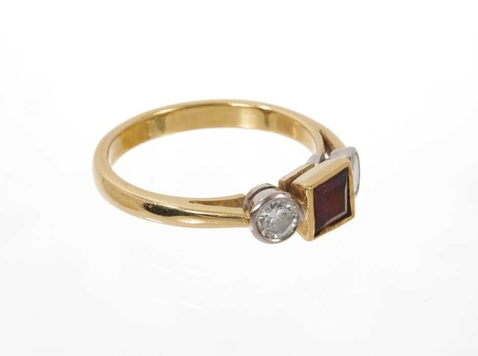 Garnet and diamond three stone ring with a square step cut garnet flanked by two round brilliant cut - Image 2 of 3