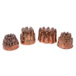Four antique copper jelly moulds, including a castelated mould numbered 213, 12.5cm high, an oval mo
