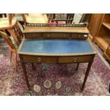 Edwardian mahogany bowfront writing table with three upper drawers, two frieze drawers on taper legs