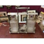 Edwardian silver plated tantalus with two cut glass decanters