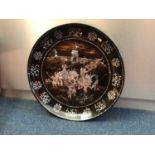 Large Eastern mother of pearl inlaid dish decorated with warriors, with character marks around the e