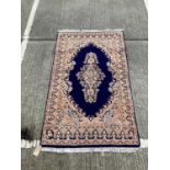 Eastern rug with geometric decoration on cream and blue ground, 201cm x 118cm