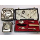 Two silver mounted watch holders containing a Goliath pocket watch and Ingersoll watch, silver chris