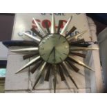 Vintage starburst clock and a barometer