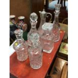 Five glass decanters and claret jug