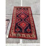 Eastern rug with geometric decoration on red and blue ground